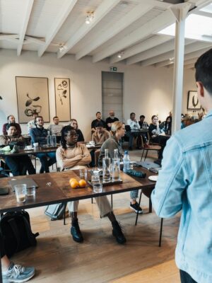 A diverse group attending a business presentation in a modern, well-lit conference room.