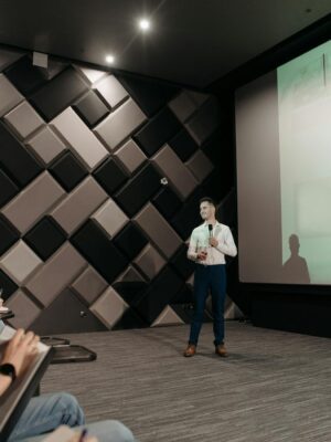 Professional business presentation in a modern conference room with attentive audience.